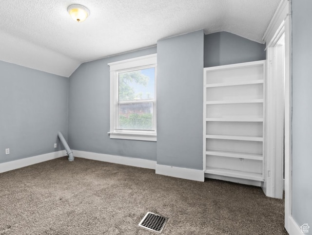 509 E 800 S, Salt Lake City, UT 84102 - additional living space with vaulted ceiling, a textured ceiling, and dark carpet