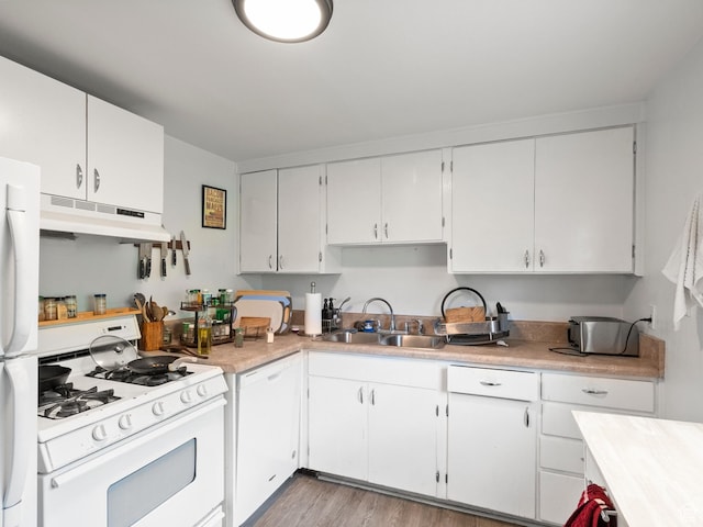 509 E 800 S, Salt Lake City, UT 84102 - kitchen with white appliances, under cabinet range hood, white cabinetry, light countertops, and light wood finished floors