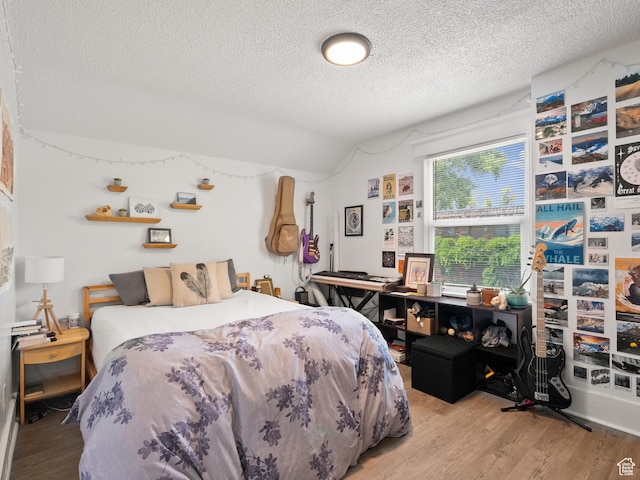 509 E 800 S, Salt Lake City, UT 84102 - bedroom with a textured ceiling, wood finished floors, and vaulted ceiling