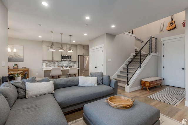 11721 N Shoreline Dr, Hideout, UT 84036 - living room featuring light wood-style floors, stairway, and recessed lighting