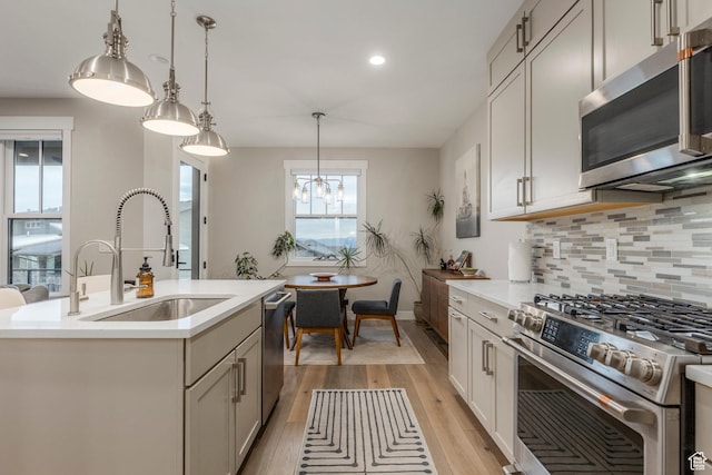 11721 N Shoreline Dr, Hideout, UT 84036 - kitchen featuring stainless steel appliances, light wood-type flooring, decorative backsplash, light countertops, and recessed lighting