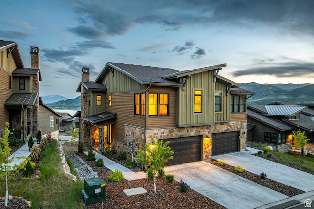 11721 N Shoreline Dr, Hideout, UT 84036 - view of front of house with board and batten siding, a mountain view, stone siding, and an attached garage