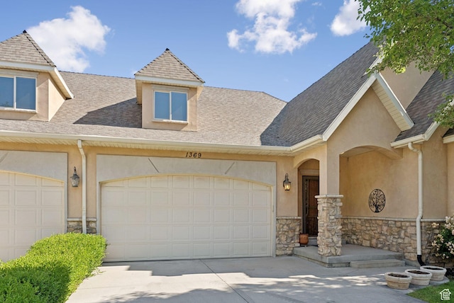 1369 E Farm Dr, Murray, UT 84117 - townhome / multi-family property featuring stone siding, driveway, stucco siding, and an attached garage