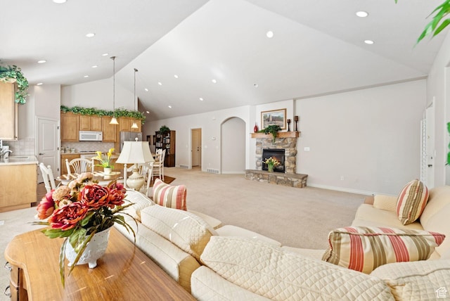 1369 E Farm Dr, Murray, UT 84117 - living area featuring high vaulted ceiling, light colored carpet, recessed lighting, and a stone fireplace