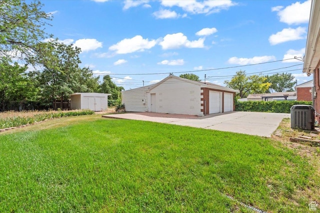 535 W Fern Dr, Midvale, UT 84047 - view of grassy yard with a detached garage and a storage unit
