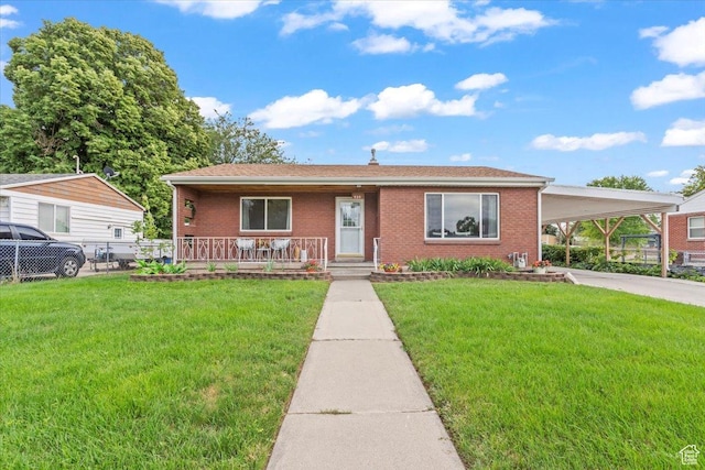 535 W Fern Dr, Midvale, UT 84047 - view of front facade with covered porch, a carport, brick siding, and driveway