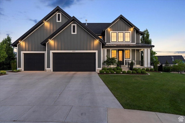 6221 W Applecross Cir, Highland, UT 84003 - view of front facade with a standing seam roof, a porch, a garage, a lawn, and driveway