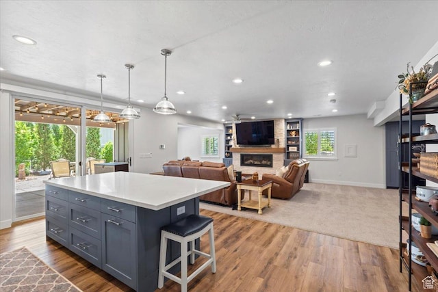 6221 W Applecross Cir, Highland, UT 84003 - kitchen with a fireplace, recessed lighting, a center island, gray cabinets, and light countertops