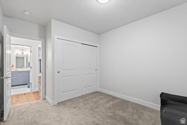 6221 W Applecross Cir, Highland, UT 84003 - unfurnished bedroom featuring light carpet, a closet, and ensuite bath