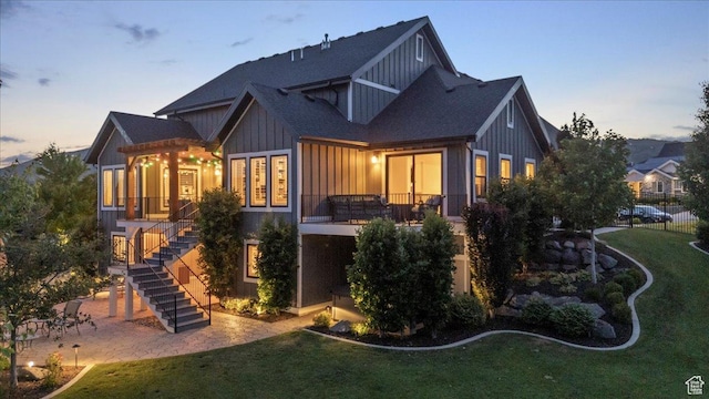 6221 W Applecross Cir, Highland, UT 84003 - rear view of property featuring stairway, board and batten siding, a lawn, roof with shingles, and a patio