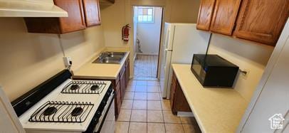 237 S 800 E, Salt Lake City, UT 84102 - kitchen featuring extractor fan, white appliances, light countertops, light tile patterned floors, and brown cabinets