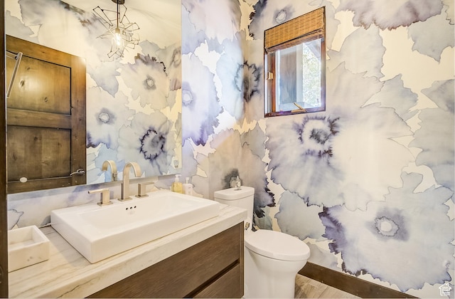 4896 Last Stand Dr, Snyderville, UT 84098 - bathroom featuring vanity, wood finished floors, and wallpapered walls