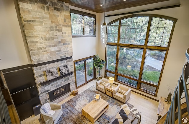4896 Last Stand Dr, Snyderville, UT 84098 - living room featuring a stone fireplace, wood ceiling, wood finished floors, recessed lighting, and a high ceiling