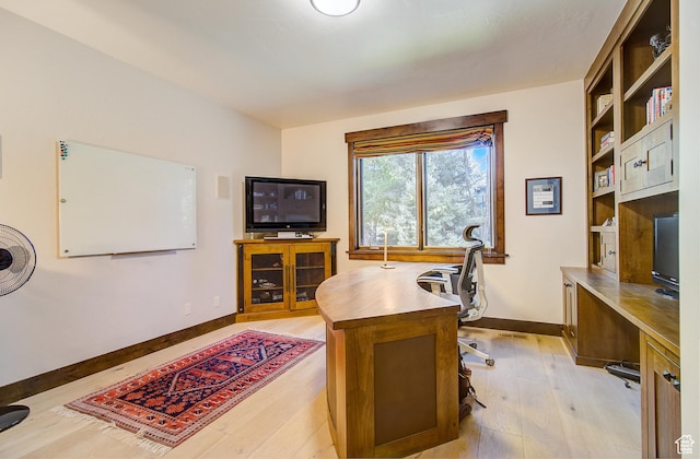 4896 Last Stand Dr, Snyderville, UT 84098 - home office featuring light wood-style flooring and built in shelves