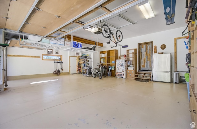 4896 Last Stand Dr, Snyderville, UT 84098 - garage with freestanding refrigerator and a garage door opener