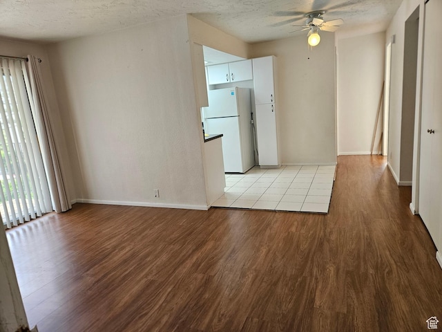 4619 S Quail Vista Ln E Unit J, Salt Lake City, UT 84117 - unfurnished room with a ceiling fan, light wood-style flooring, and a textured ceiling