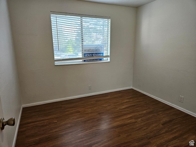 4619 S Quail Vista Ln E Unit J, Salt Lake City, UT 84117 - spare room with baseboards and wood finished floors
