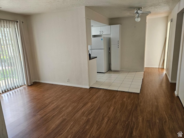 4619 S Quail Vista Ln E Unit J, Salt Lake City, UT 84117 - empty room with ceiling fan, light wood-type flooring, and a textured ceiling