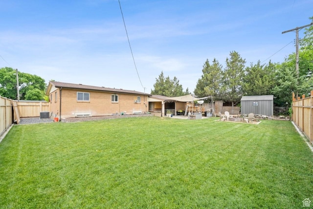 1856 N Alder St, Layton, UT 84041 - rear view of property with a fenced backyard, a shed, brick siding, and a patio