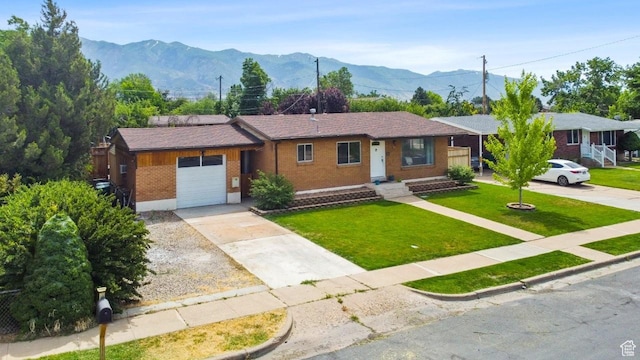 1856 N Alder St, Layton, UT 84041 - ranch-style house with brick siding, an attached garage, driveway, a front yard, and a mountain view