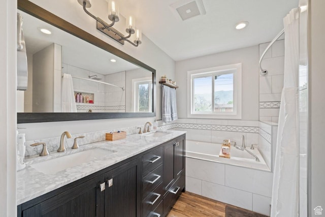 1856 N Alder St, Layton, UT 84041 - bathroom featuring a garden tub, tiled shower, double vanity, wood finished floors, and recessed lighting