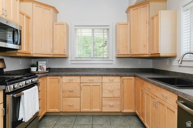 287 S 375 W, Providence, UT 84332 - kitchen with appliances with stainless steel finishes, light brown cabinetry, dark countertops, and tile patterned flooring