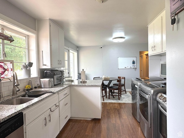615 E Ben Lomond Ave, South Ogden, UT 84403 - kitchen featuring dishwasher, a peninsula, dark wood finished floors, and white cabinetry