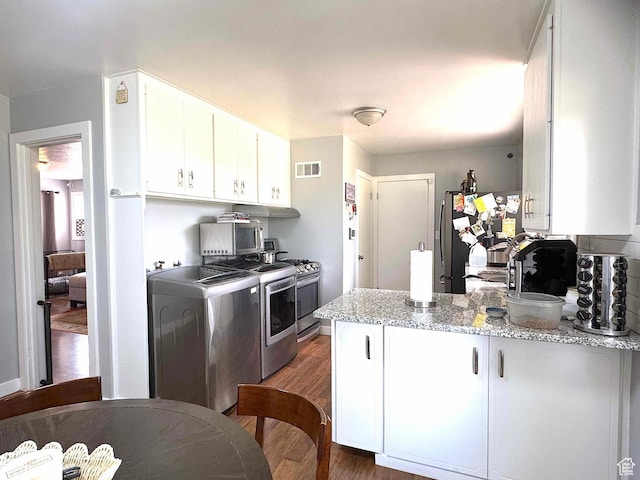 615 E Ben Lomond Ave, South Ogden, UT 84403 - kitchen featuring appliances with stainless steel finishes, white cabinets, a peninsula, dark wood-style floors, and light stone countertops