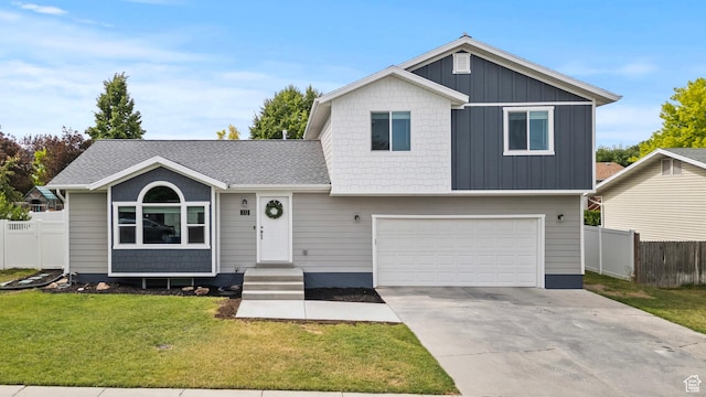 332 E 2475 N, North Logan, UT 84341 - tri-level home featuring an attached garage, board and batten siding, concrete driveway, and roof with shingles