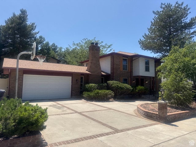 2650 E Willow Wick Dr, Sandy, UT 84093 - traditional home featuring brick siding, driveway, a garage, and a chimney