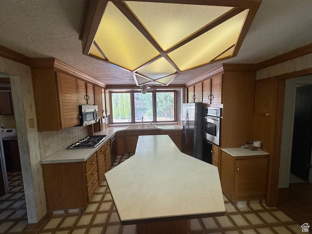 2650 E Willow Wick Dr, Sandy, UT 84093 - kitchen with stainless steel appliances, light flooring, brown cabinetry, light countertops, and a textured ceiling