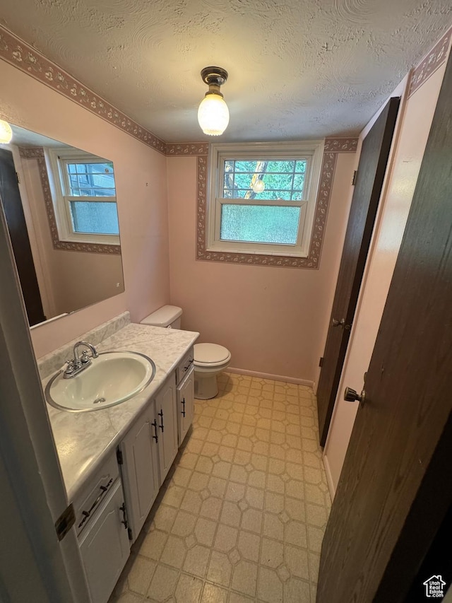 2650 E Willow Wick Dr, Sandy, UT 84093 - bathroom featuring tile patterned floors, vanity, and a textured ceiling