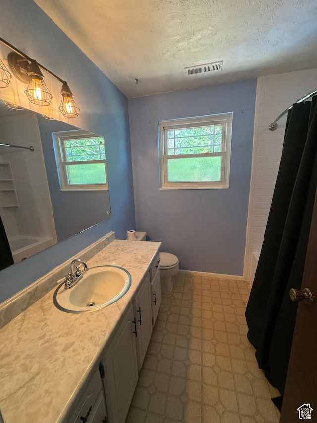 2650 E Willow Wick Dr, Sandy, UT 84093 - bathroom with vanity, plenty of natural light, tile patterned floors, a textured ceiling, and shower / bath combination with curtain