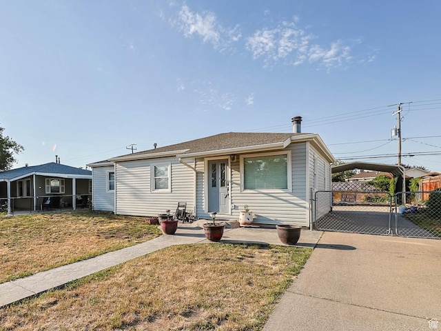 4281 W 5780 S, Salt Lake City, UT 84118 - view of front of house with a carport, a gate, and a sunroom