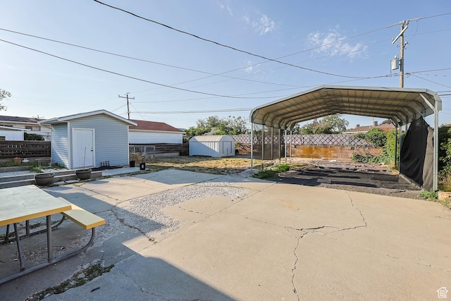 4281 W 5780 S, Salt Lake City, UT 84118 - view of patio / terrace with a storage shed, a carport, and driveway