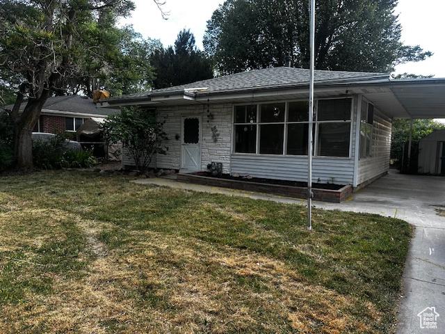 3700 S 3325 W, West Valley City, UT 84119 - view of front of home featuring a carport, concrete driveway, and a front lawn