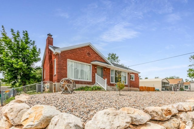 3071 Quincy Ave, Ogden, UT 84403 - view of front facade with brick siding and a chimney