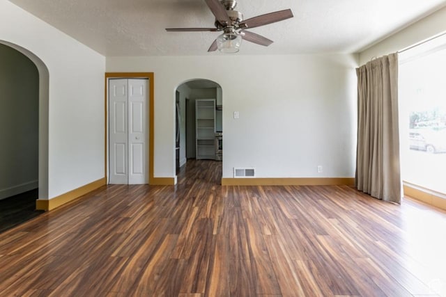3071 Quincy Ave, Ogden, UT 84403 - unfurnished room with arched walkways, wood finished floors, ceiling fan, and a textured ceiling