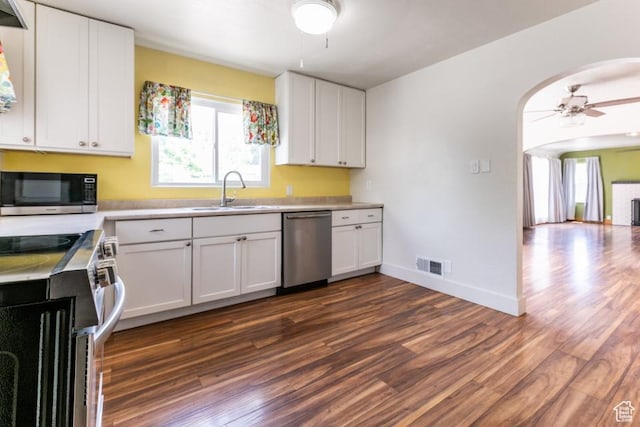 3071 Quincy Ave, Ogden, UT 84403 - kitchen with stainless steel appliances, a ceiling fan, dark wood-style flooring, and arched walkways