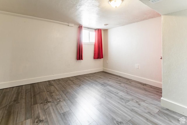 3071 Quincy Ave, Ogden, UT 84403 - empty room with a textured ceiling and wood finished floors