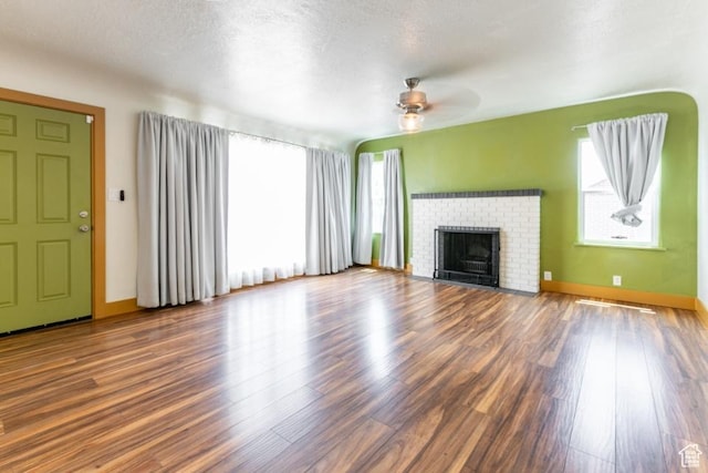 3071 Quincy Ave, Ogden, UT 84403 - unfurnished living room with ceiling fan, wood finished floors, and a fireplace
