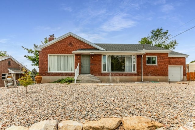 3071 Quincy Ave, Ogden, UT 84403 - view of front of home with a chimney, a garage, and brick siding