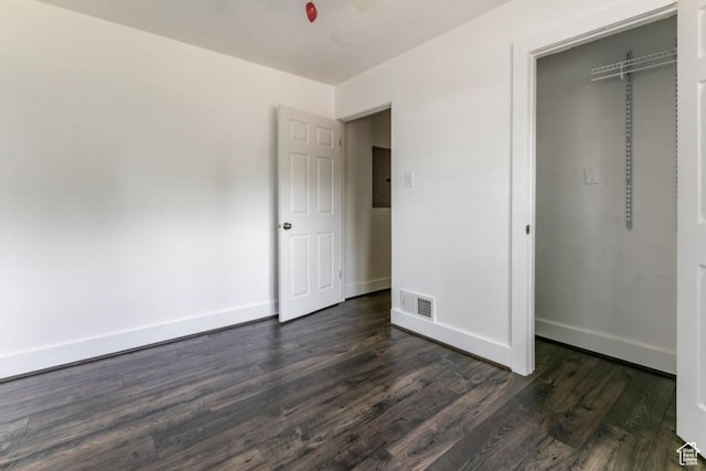 3071 Quincy Ave, Ogden, UT 84403 - unfurnished bedroom featuring electric panel, dark wood-style flooring, and a closet