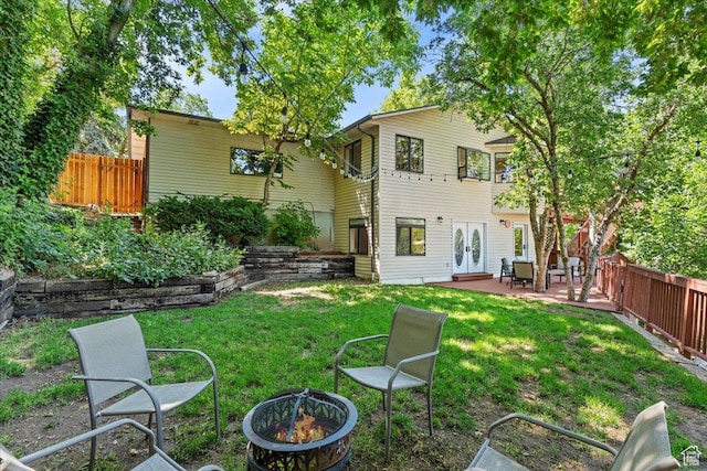 5791 S Oakwood Dr W, South Ogden, UT 84405 - rear view of property with a fire pit, french doors, a fenced backyard, and a patio