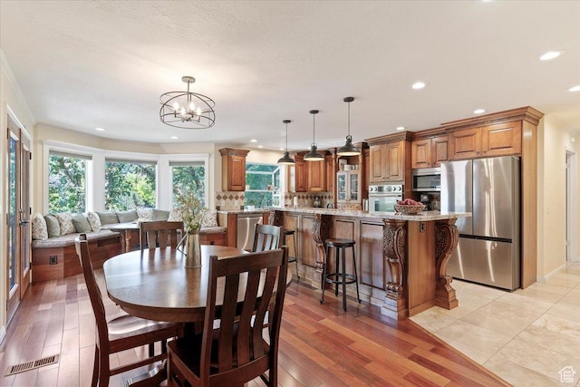 5791 S Oakwood Dr W, South Ogden, UT 84405 - dining area with recessed lighting, a chandelier, and light wood-style floors