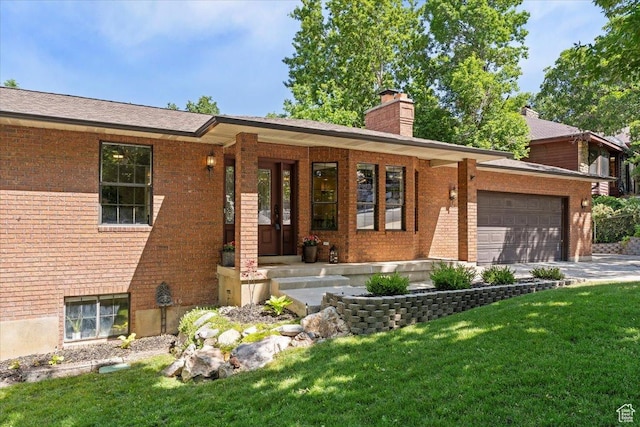 5791 S Oakwood Dr W, South Ogden, UT 84405 - ranch-style house with brick siding, a chimney, a front lawn, an attached garage, and driveway