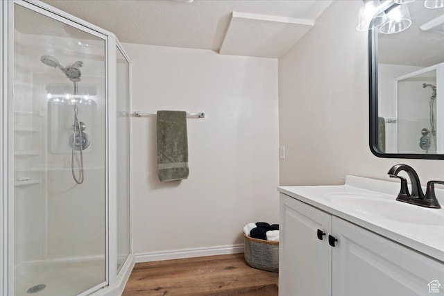 5791 S Oakwood Dr W, South Ogden, UT 84405 - bathroom featuring a shower stall, wood finished floors, and vanity