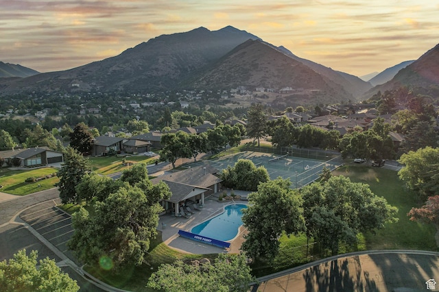 3683 E Cove Point Dr, Millcreek, UT 84109 - aerial view at dusk of view of pool, a mountain view, and a residential view