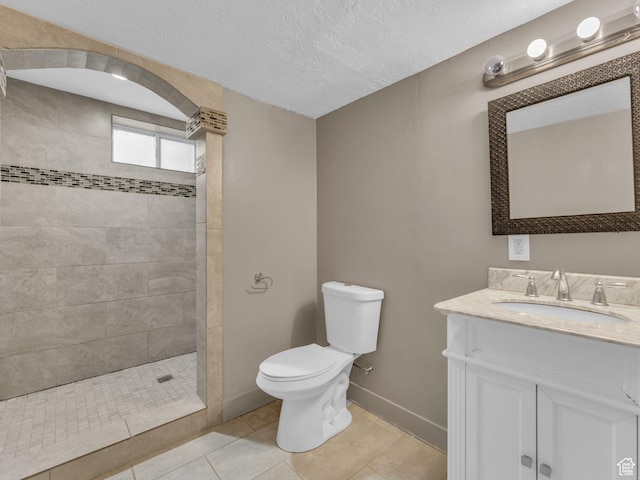 787 E Casa Blanco Cir, Midvale, UT 84047 - bathroom with vanity, tiled shower, tile patterned floors, and a textured ceiling