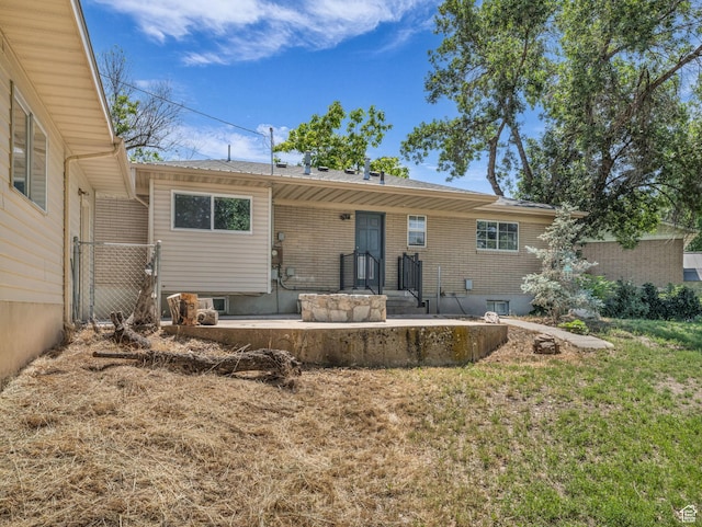 787 E Casa Blanco Cir, Midvale, UT 84047 - back of property featuring brick siding and a lawn
